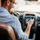 Man distracted on phone while driving.