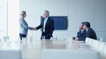 a client shaking hands with an attorney